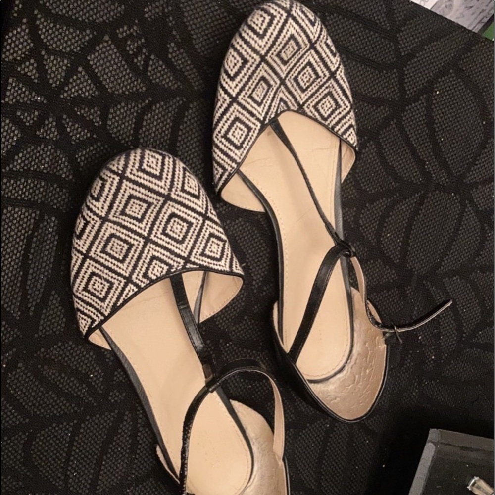Clasping black and white flats.
